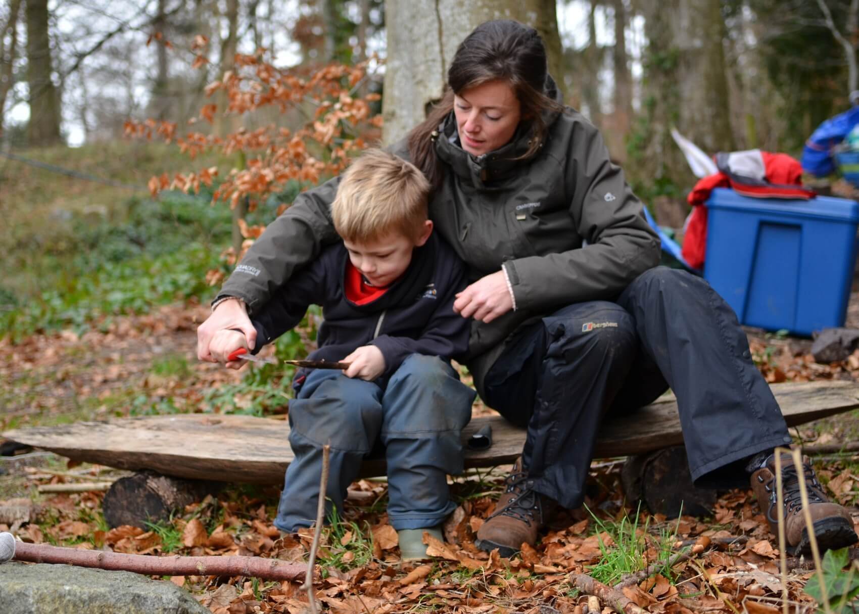 A child learning how to use a knife safely at Nature Nurture