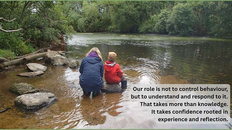 Professional Confidence - 'Our role is not to control behaviour' – adult and child sitting on a rock in a river