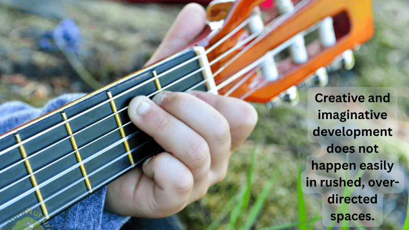 Creative and Imaginative Development (child’s hand playing a guitar in outdoor setting)